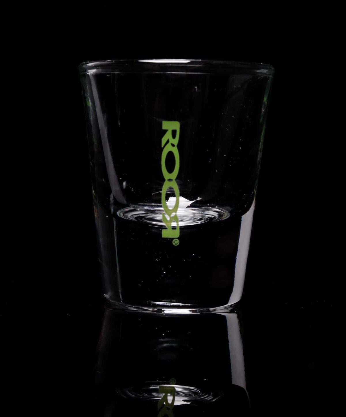 ROOR Shot Glass with thick clear base and green logo.